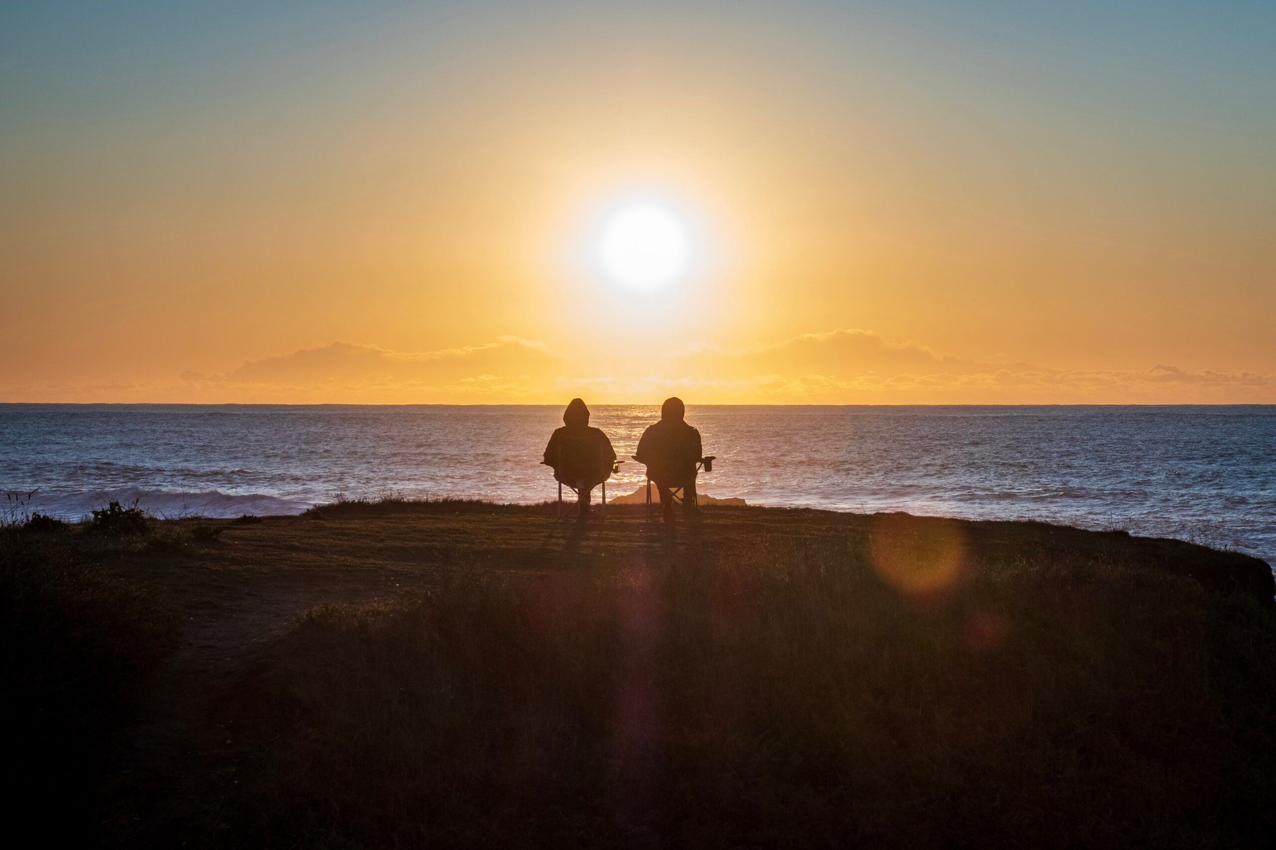 Couple enjoying retirement by watching the sunset.