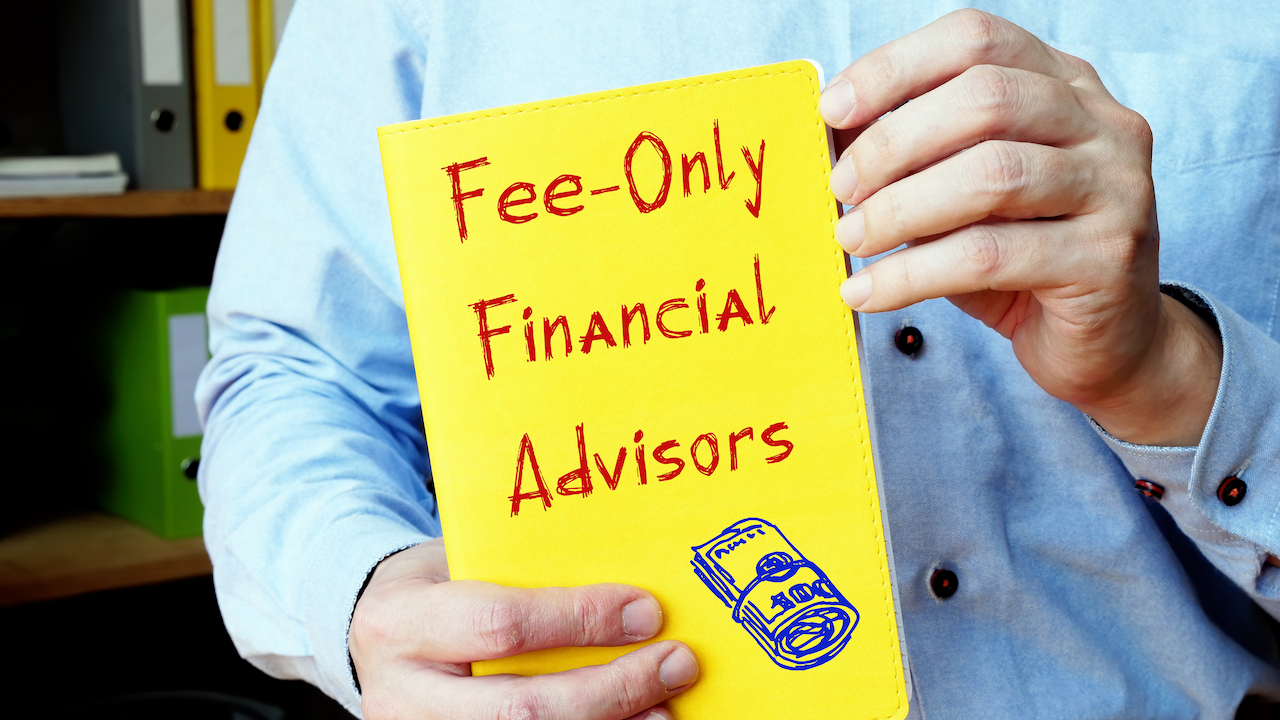 A man holds a sign saying "Fee-only financial advisors".