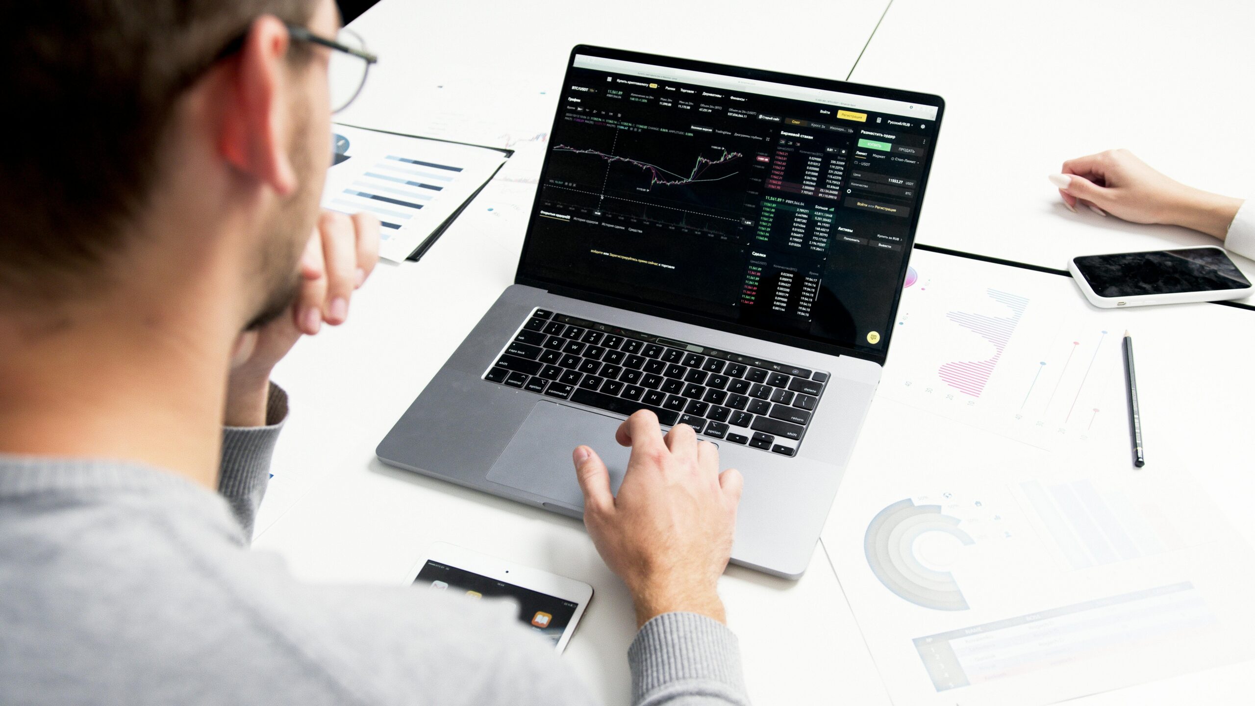 A man looks at how his stocks are tracking on his laptop.